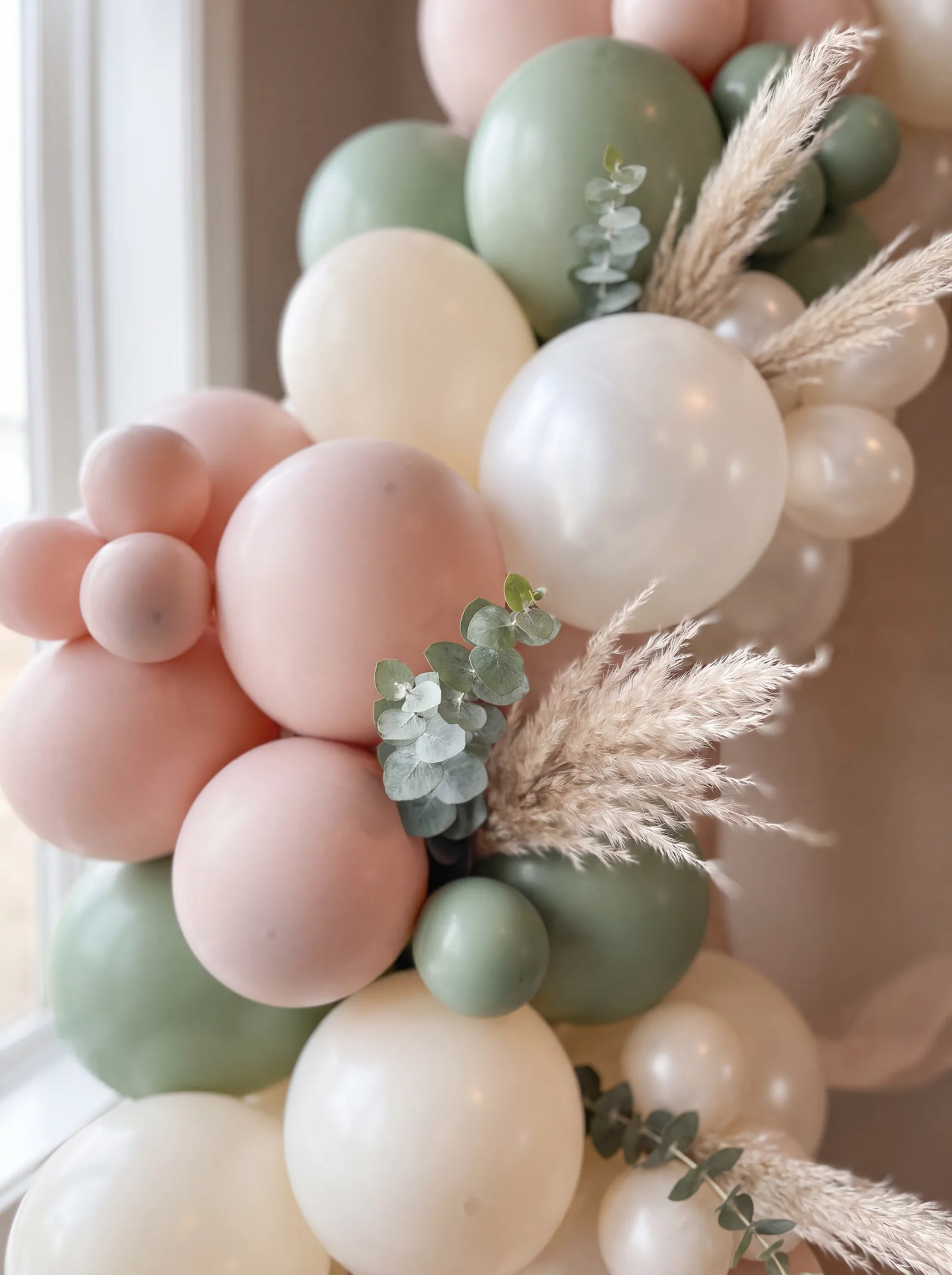 Close up of a blush, sage and ivory garland with eucalyptus and pampas