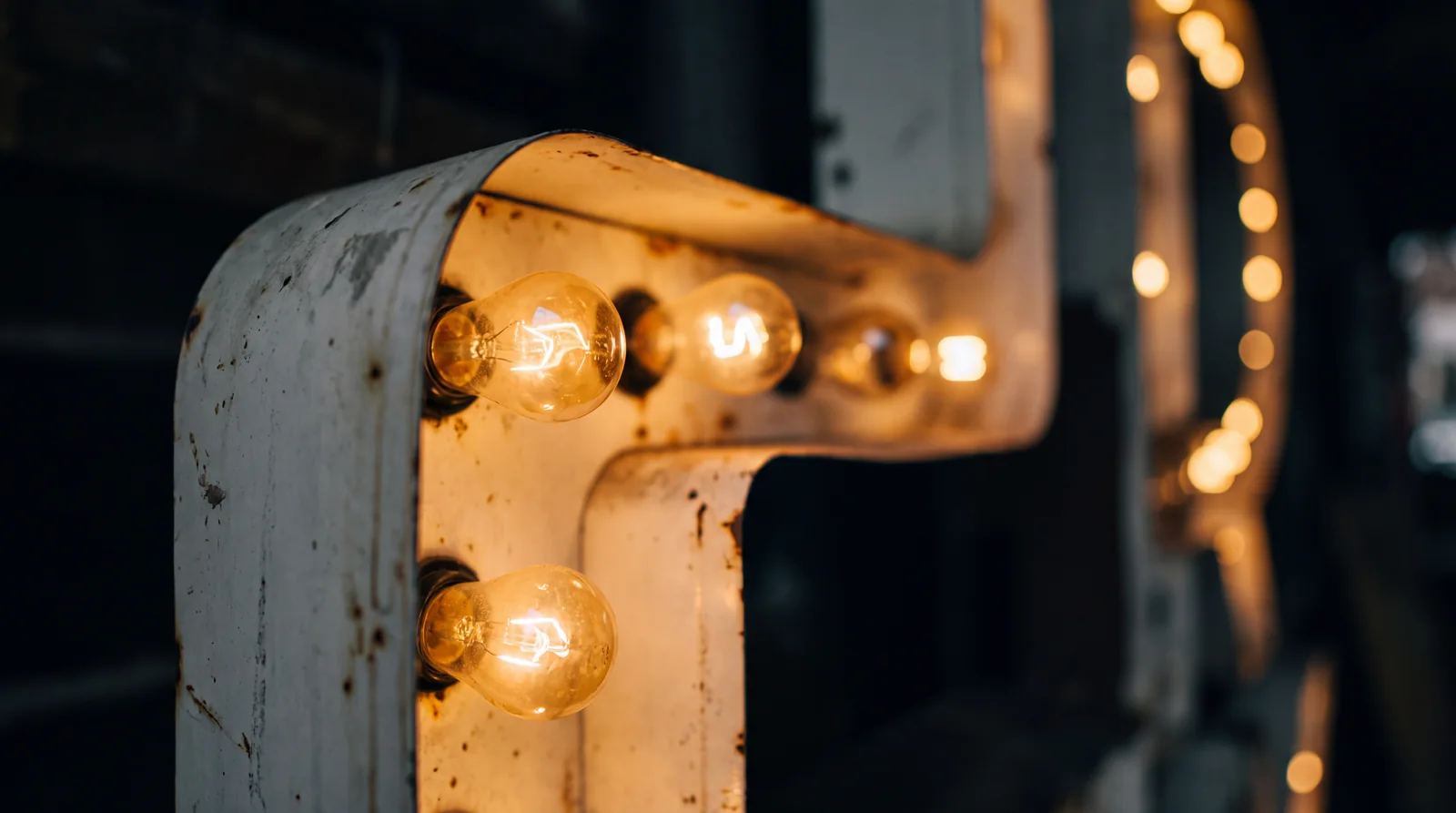 Close up of the warm filament bulbs along the edge of a light up letter