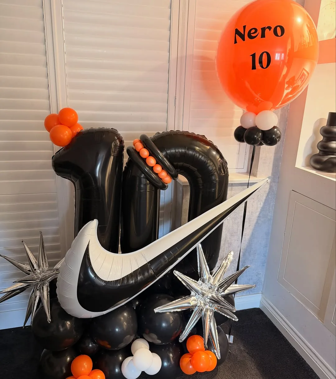 Black and orange number ten balloons with a garland