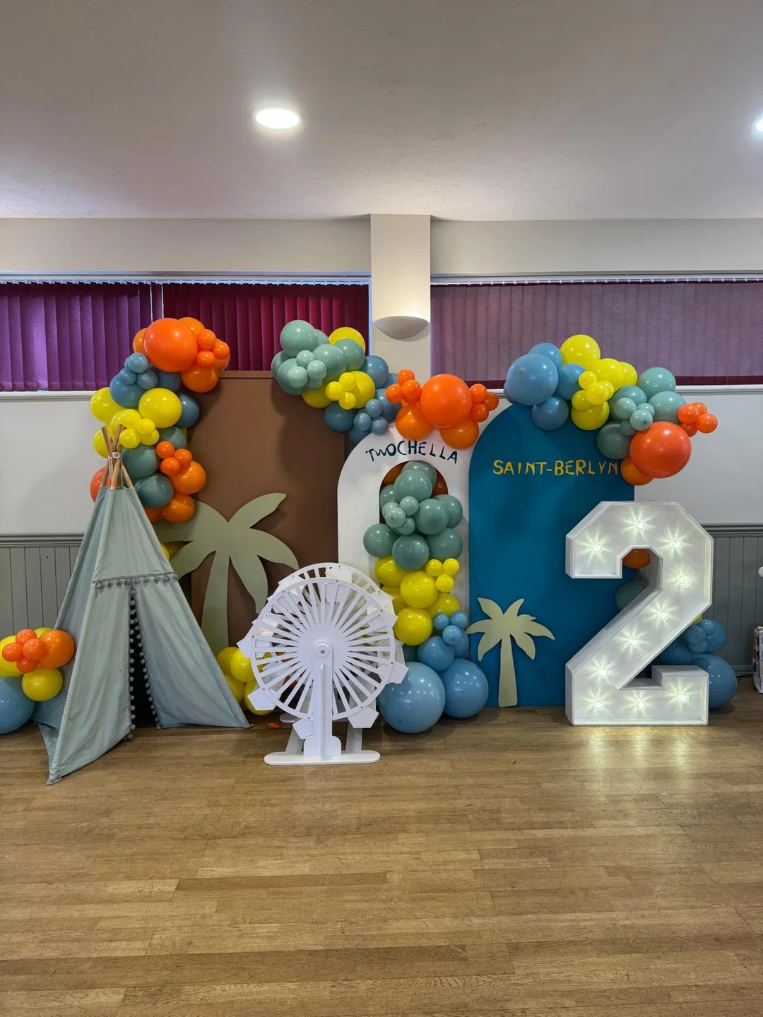 A travel themed second birthday with a teepee, a ferris wheel prop and a light up 2