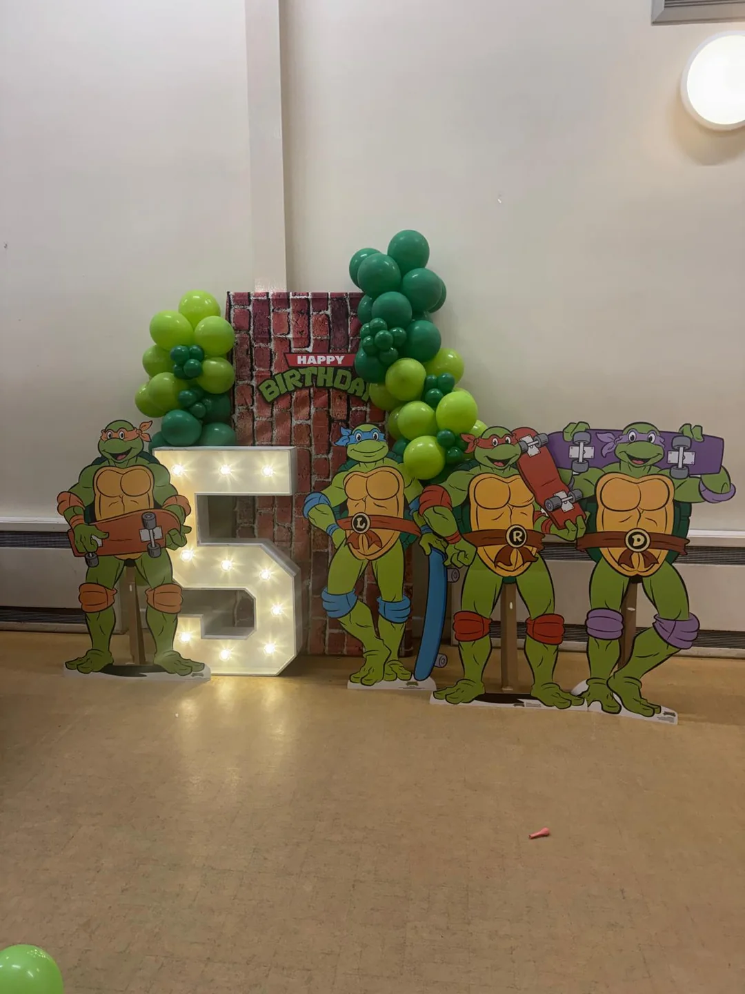 A Teenage Mutant Ninja Turtles fifth birthday with character cutouts and a light up 5