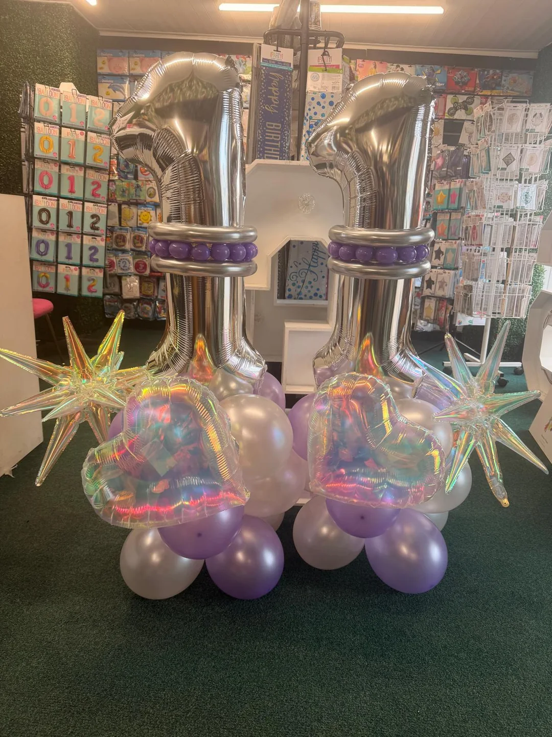 Silver foil number balloons with starburst and pastel balloon bases in the shop