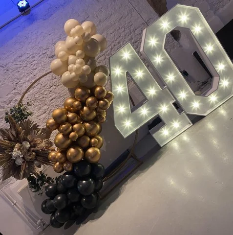Light up 40 with a gold, black and ivory garland